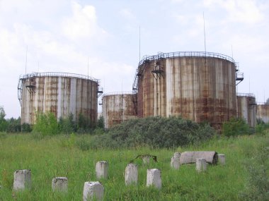 large rusty bunkers storage tanks for fuel and gasoline abandone
