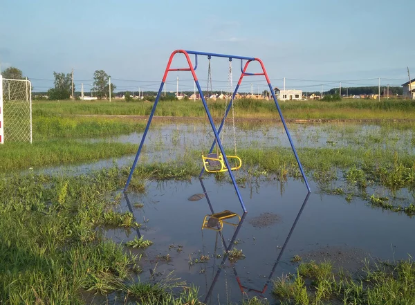 Flooded children's Playground on the street in a pool of water s — Stock Photo, Image