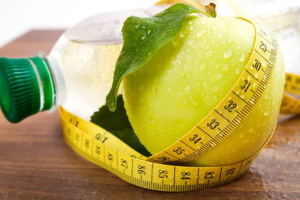 Apple core with water drops, bottled water for healthy life — Stock Photo, Image