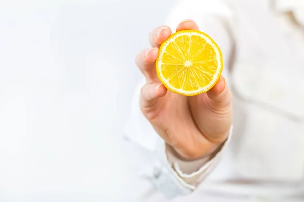 Women Hand Holding a lemon isolated on white — Stock Fotó