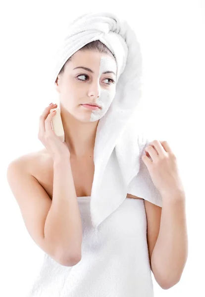 Woman in headband with lifting cream applied on a half of her fa — Stock Photo, Image