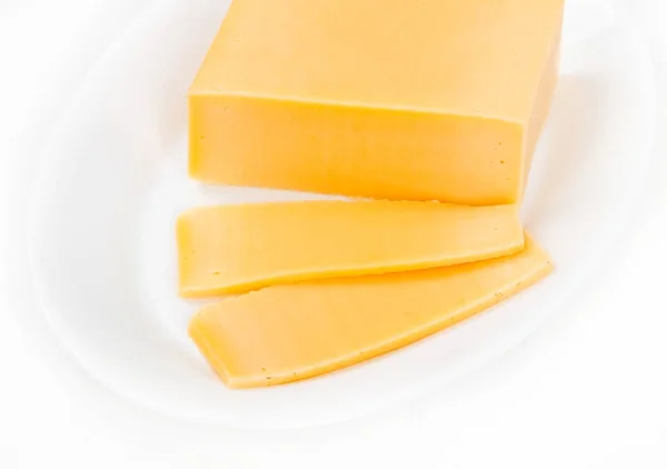 Slices of cheese in a plate, on a white background — Stock Photo, Image