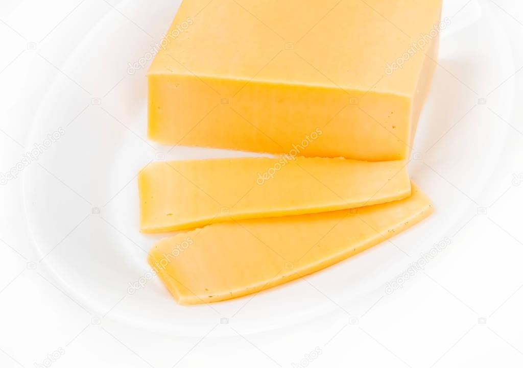 Slices of cheese in a plate, on a white background — Stock Photo