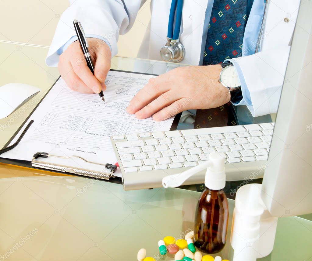 doctor writing prescription patient data history while sitting at workplace 