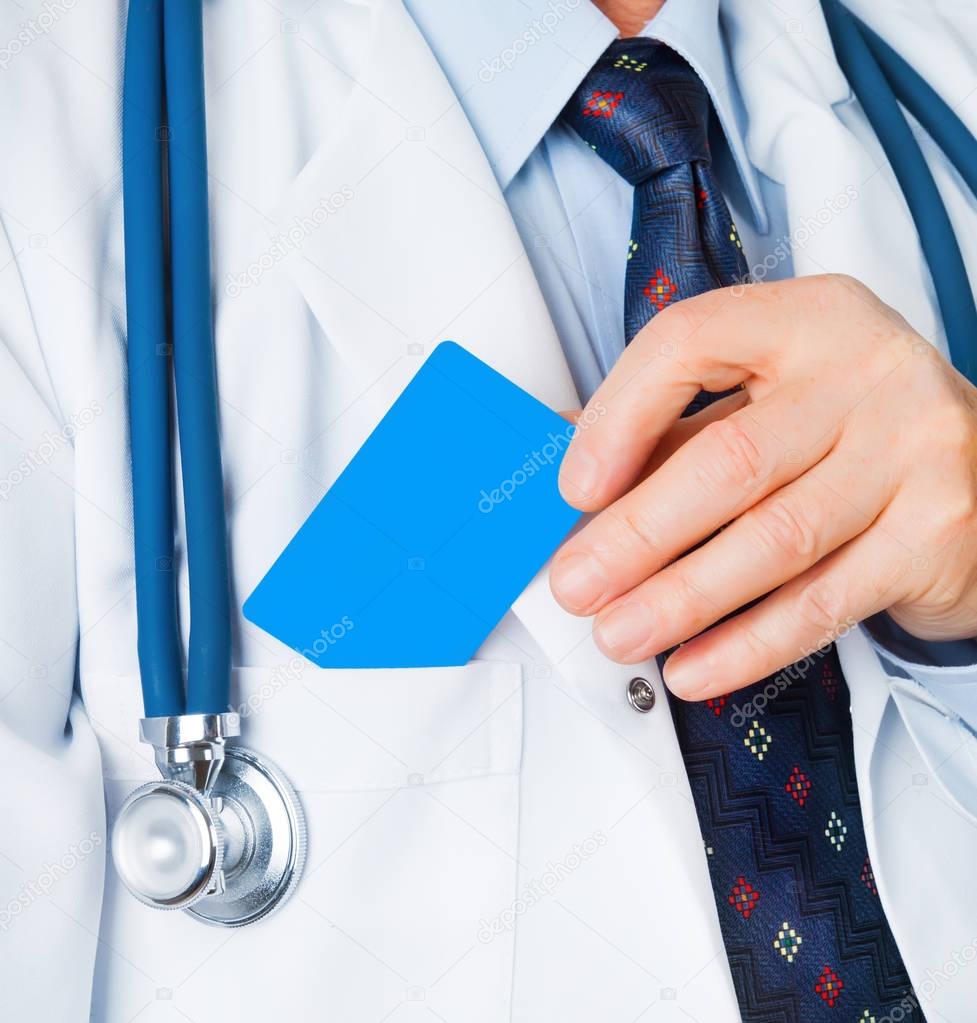 close-up of doctor putting empty blue card in pocket