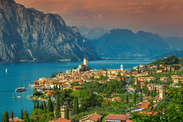 Stunning Garda lake with high mountains in background and wonderful Malcesine tourist resort, Italy, Europe