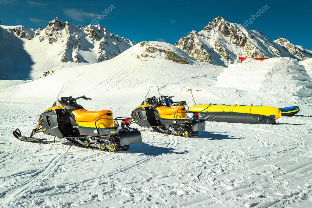 Group of yellow snowmobiles in mountains, Balea lake, Transylvania, Romania 