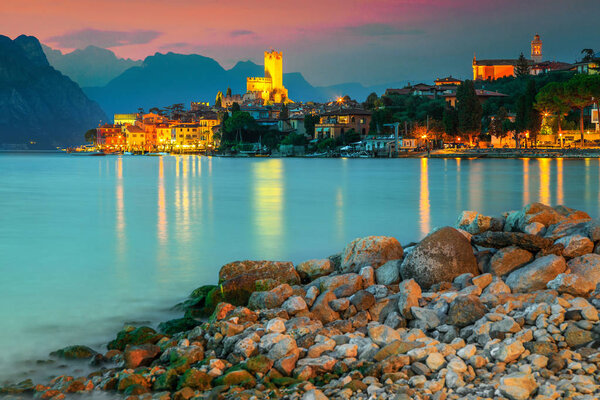 Fantastic Malcesine touristic recreation resort, colorful sky with stunning sunset, Garda lake, Veneto region, Italy, Europe