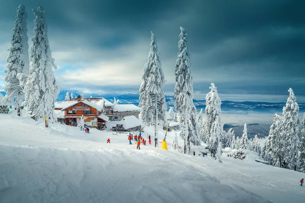 Skidort med skidåkare i backen, Poiana Brasov, Rumänien — Stockfoto