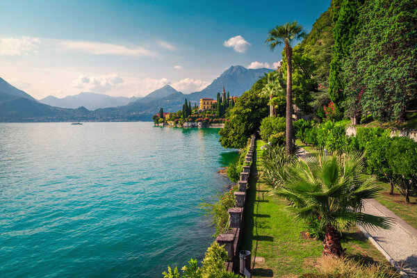 Amazing location with lake and mediterranean buildings. Cute promenade with mediterranean and tropical plants, lake Como, Varenna, Lombardy region, Italy, Europe