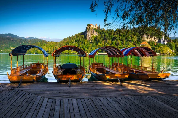 Wooden Pletna boats anchored on the lake Bled, Slovenia — Stock Photo, Image