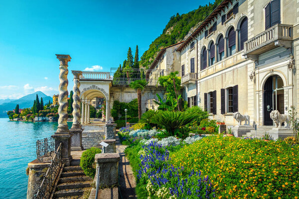Touristic villa Monastero and amazing ornamental garden with colorful flowers in Varenna resort, lake Como, Lombardy region, Italy, Europe