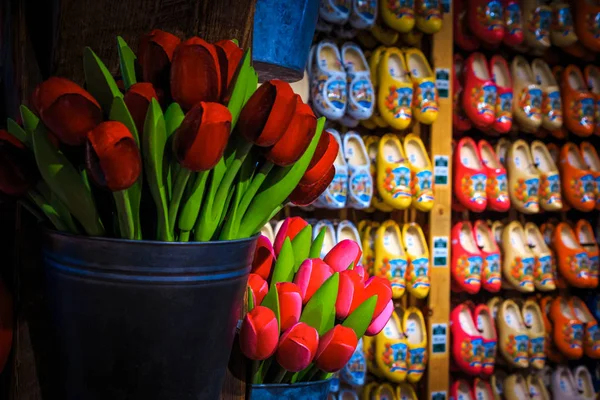 Traditional wooden shoes and wooden tulips in souvenir shop, Netherlands