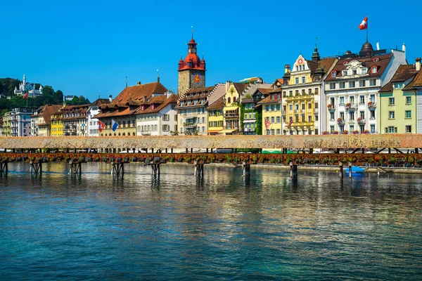 Swiss touristic and travel location in Lucerne. Admirable cityscape view with flowered wooden Chapel bridge on the Reuss river, Luzern, Switzerland, Europe