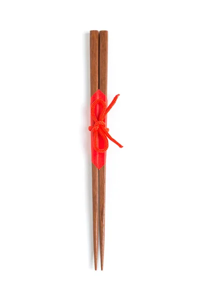 Japanese wooden chopsticks wrapped in red paper and red rope on — Stock Photo, Image
