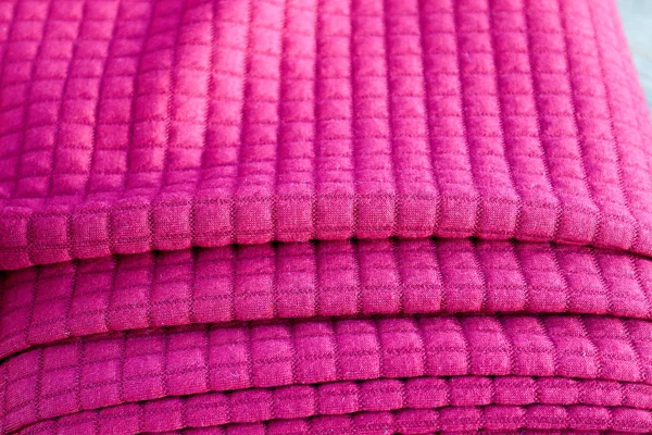 Close up view on folded cloth and fabric textures in different colors