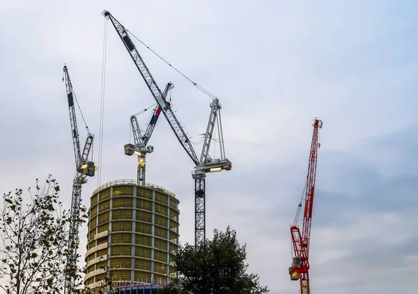 Several cranes on constructions sites at high buildings all over London UK