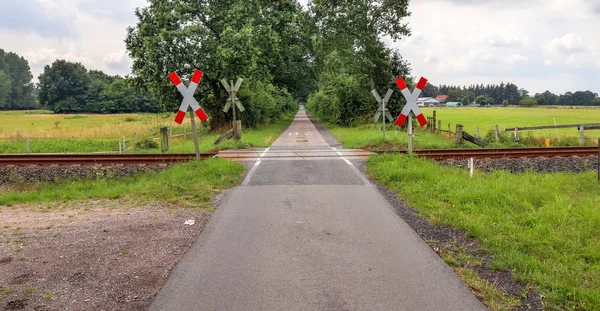 Railroad crossing at a country road on a summer day