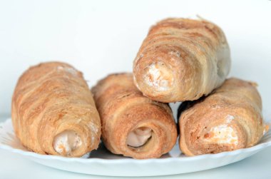 cream cakes with protein cream on a white plate. The concept is to lose weight, healthy nutrition, unhealthy diet.