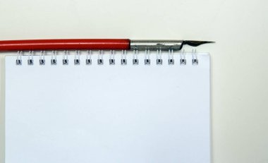 Fountain pen metallic pen on write on a notepad sheet. Copy space