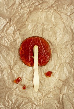Useful sweetness. Lollipop made at home from natural ingredients on Kraft paper. Concept of environmental products. Food photo, horizontal orientation, top view