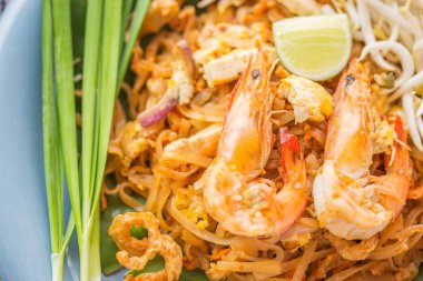 Pad Thai - Rice noodles with shrimps and vegetables close-up on 
