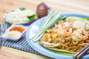 Pad Thai - Rice noodles with shrimps and vegetables close-up on 