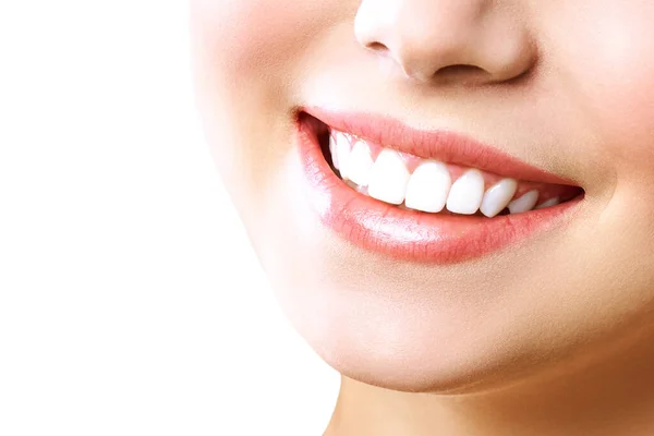 Stomatology concept. Partial portrait of a girl with white teeth smiling. Closeup of young woman at dentists, studio, indoors. isolated on white background. — Stockfoto