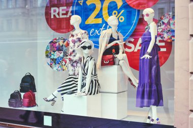 Boutique window with dressed mannequins clipart