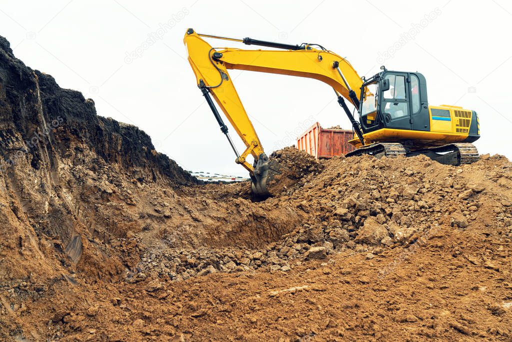 A large construction excavator of yellow color on the construction site in a quarry for quarrying. Industrial image