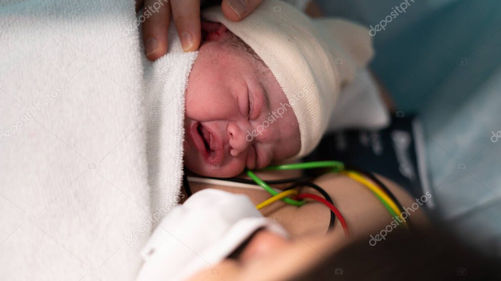 newborn boy with the covid-19 crying
