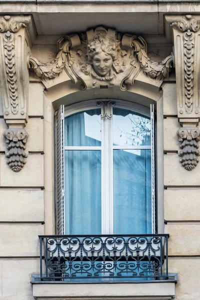 Paris, typical building, parisian window, womans head carved on the lintel of a window