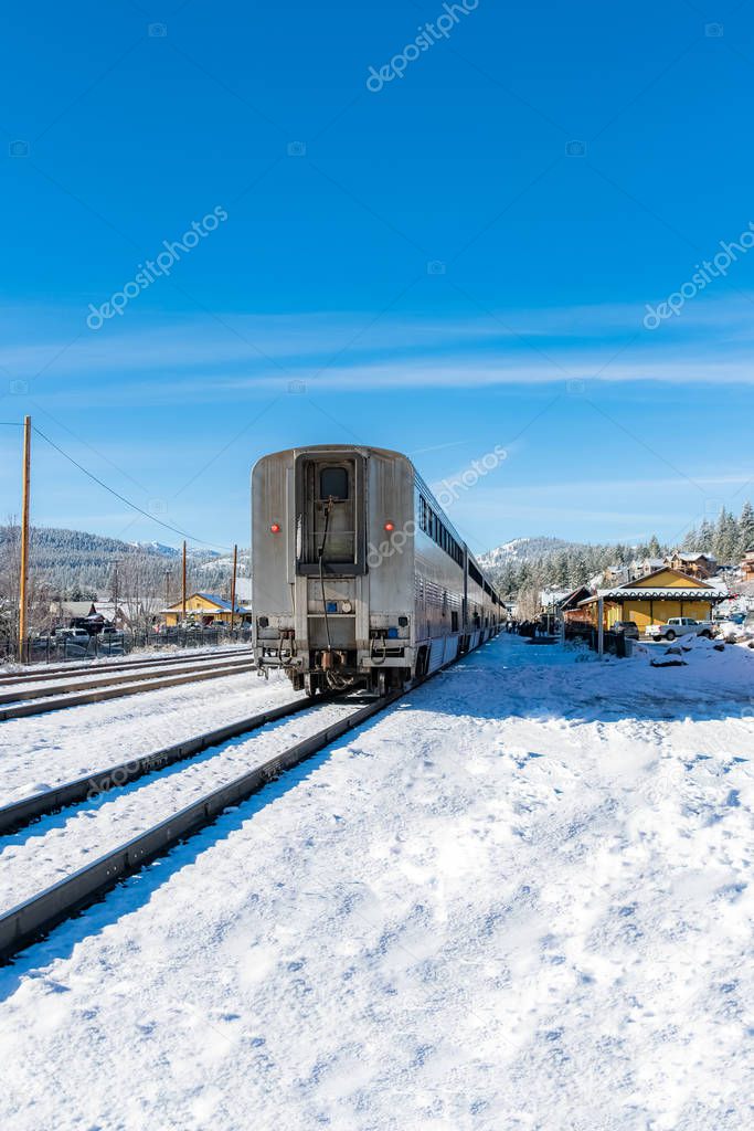 A locomotive crossing in Truckee, California, with snowy mountains in background