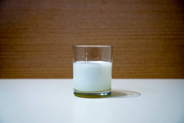 Glass beaker full of milk on the table