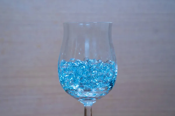 Blue glass gems in a wine glass