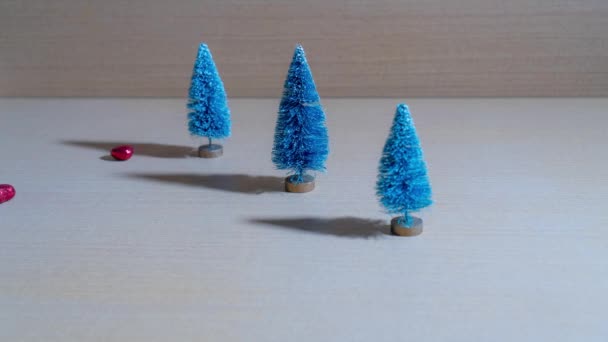 Christmas objects flow through the Christmas trees — Stock Video