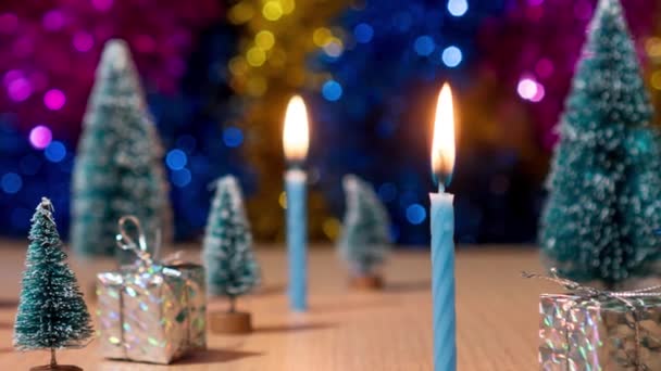 Candles burn in timelapse amid gifts and Christmas trees — ストック動画