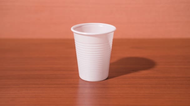 Пластиковая чашка складывается в комок — стоковое видео