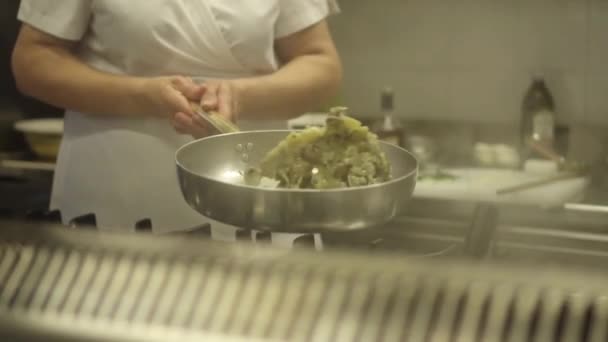 Моллюски помешивают на сковороде на кухне. — стоковое видео