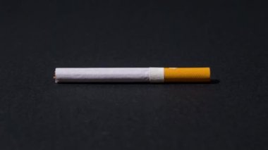 Cigarette breaks in two in stop motion