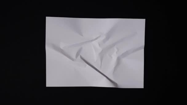 A lump of paper becomes A4 sheet — Stock Video