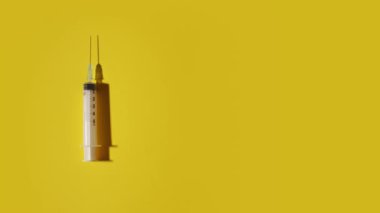 Syringe moves on the yellow surface