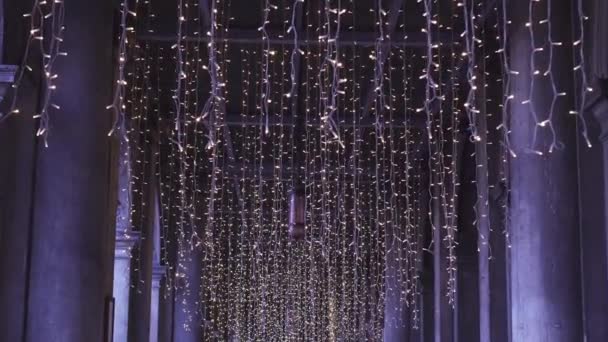 Christmas lights under the arcades of the city — Stockvideo