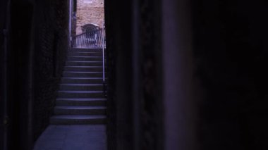 narrow calle of Venice with steps on the bridge