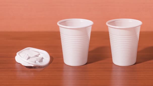 Three disposable plastic cups break — Stockvideo