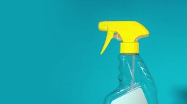 Detergent bottle makes spray spray on blue background