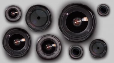 Many photographic lenses in group on a white background