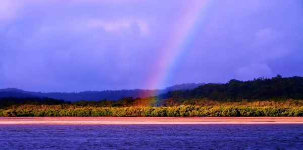 Translucent vibrant Rainbow near water. — Stock Photo, Image