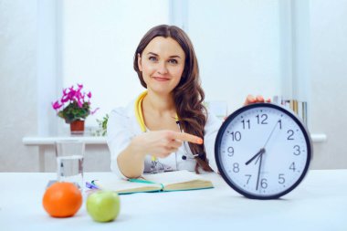 Sağlık ve blog konsepti - genç güzel kadın doktor beslenme ve spor egzersizlerinden bahsediyor