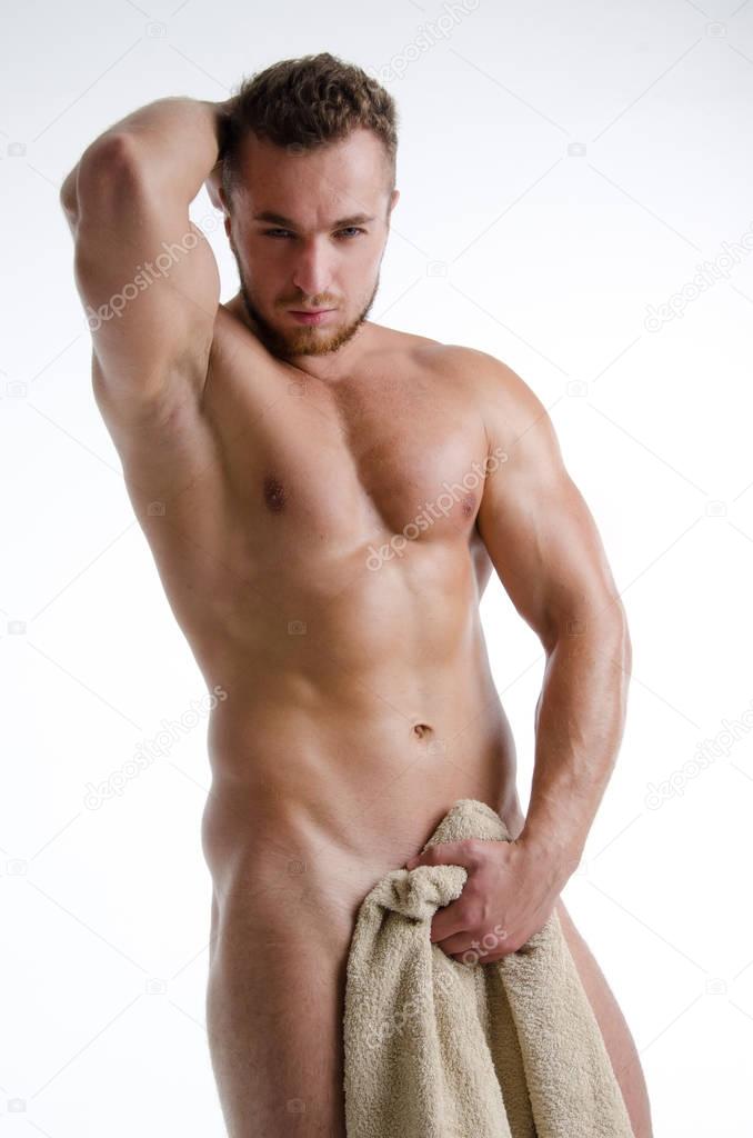 Young sexy man wrapped in a towel.